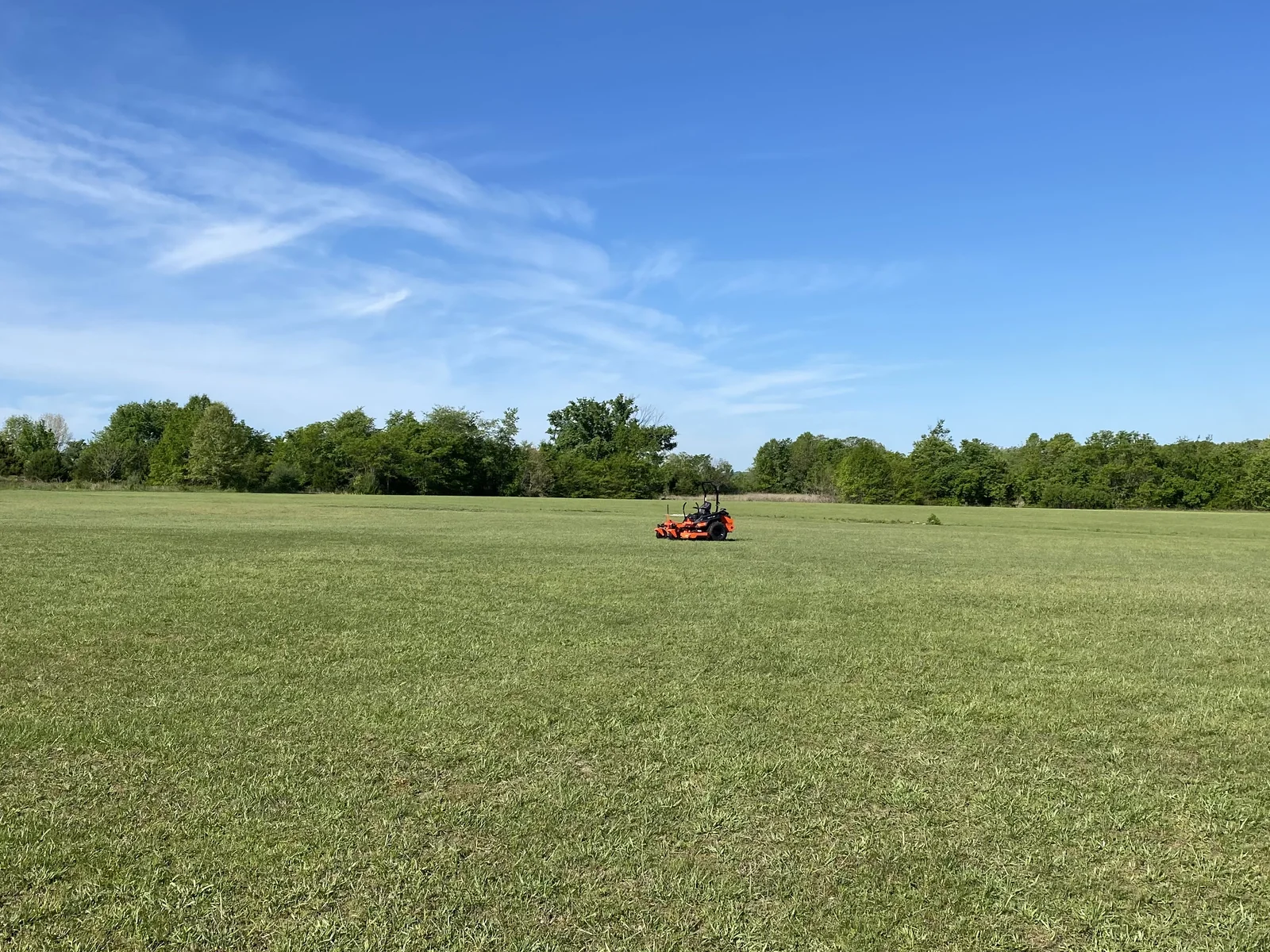 The Bad Boy Rogue 72" in the field — wide shot under blue sky